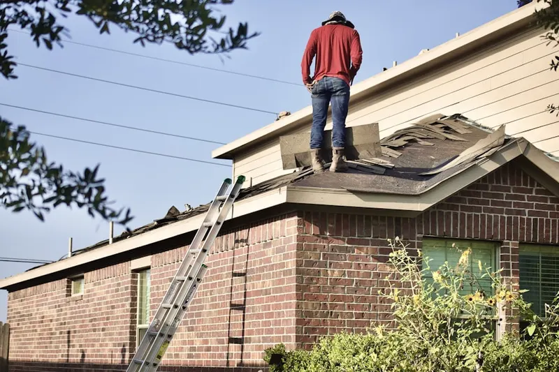 Professional roofer working on a residential roof in Bethpage